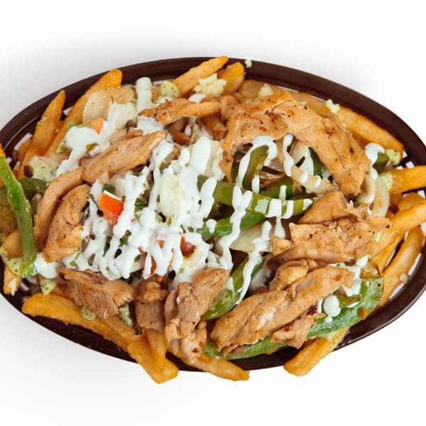 Loaded fries with grilled chicken, green peppers, onions, and creamy white sauce in a basket.