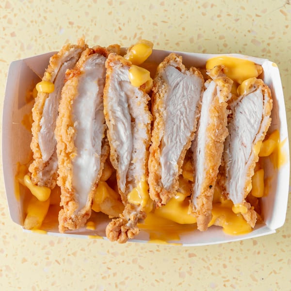Crispy fried chicken strips and golden fries smothered in melted cheese sauce.